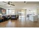 Open floor plan living room featuring a ceiling fan, a brown sofa and view of the outdoor pool at 7415 W Via De Luna Dr, Glendale, AZ 85310
