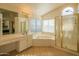 Bathroom suite with tub, tiled flooring, walk-in shower, and plenty of natural light at 7415 W Via De Luna Dr, Glendale, AZ 85310
