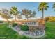 Landscaped community entrance sign for Hillcrest with palm trees and flowers at 7415 W Via De Luna Dr, Glendale, AZ 85310