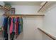 Spacious walk-in closet with wooden racks and shelves for ample storage at 7415 W Via De Luna Dr, Glendale, AZ 85310