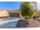 Exterior showcasing a two-car garage and desert landscaping at 8071 W Valor Way, Florence, AZ 85132