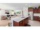 Modern kitchen featuring stainless steel appliances, dark wood cabinets, and center island at 8071 W Valor Way, Florence, AZ 85132