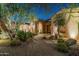 Inviting desert home entrance featuring a stone walkway and mature desert landscaping at 8496 E Homestead Cir, Scottsdale, AZ 85266