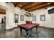 Game room with a pool table, wood ceiling beams, and natural light from large windows at 8496 E Homestead Cir, Scottsdale, AZ 85266