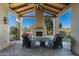 Covered outdoor patio area with fireplace and comfortable seating at 8496 E Homestead Cir, Scottsdale, AZ 85266