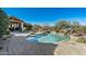 Resort-style pool with rock features, putting green and covered patio at 8496 E Homestead Cir, Scottsdale, AZ 85266