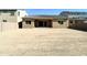 Home back exterior with desert landscaping, neutral colors and a covered patio at 8723 W Vista Ave, Glendale, AZ 85305