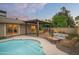 This backyard features a pool, an outdoor kitchen, and a covered dining area at 8740 E Mulberry St, Scottsdale, AZ 85251