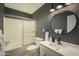 This bathroom offers a shower-tub combo, updated lighting, and a stylish circular mirror at 8740 E Mulberry St, Scottsdale, AZ 85251