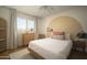 Bright bedroom featuring a large circular accent wall and natural light, enhancing comfort and style at 8740 E Mulberry St, Scottsdale, AZ 85251