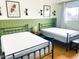 Shared bedroom with two iron beds, providing a comfortable and stylish space for restful nights at 8740 E Mulberry St, Scottsdale, AZ 85251
