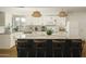 Kitchen showcasing white cabinetry, stainless steel appliances, and a dark-colored kitchen island at 8740 E Mulberry St, Scottsdale, AZ 85251