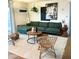 Comfortable living room with a green sectional sofa and a pair of round wood coffee tables at 8740 E Mulberry St, Scottsdale, AZ 85251