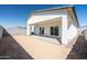 View of the backyard with a covered patio and sliding glass doors at 909 E Desert Ln, Phoenix, AZ 85042