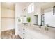 Bright bathroom with double vanity, framed mirrors, and modern fixtures at 909 E Desert Ln, Phoenix, AZ 85042