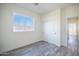 Bedroom featuring modern flooring, bright windows, and a sliding door closet at 909 E Desert Ln, Phoenix, AZ 85042