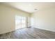 Bright bedroom with wood-look floors and sliding glass doors to the backyard at 909 E Desert Ln, Phoenix, AZ 85042