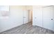Empty bedroom with wood-look flooring, a sliding closet door, and natural light at 909 E Desert Ln, Phoenix, AZ 85042