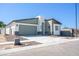Front view of a home with a two-car garage, desert landscaping, and modern design at 909 E Desert Ln, Phoenix, AZ 85042