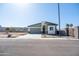 Modern single-story home with neutral color palette, garage, and desert landscaping at 909 E Desert Ln, Phoenix, AZ 85042