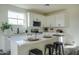 A stylish white kitchen with quartz countertops, stainless steel appliances, and ample storage at 909 E Desert Ln, Phoenix, AZ 85042