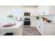 Bright kitchen featuring white cabinets, stainless steel appliances, and modern finishes at 909 E Desert Ln, Phoenix, AZ 85042