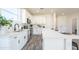 Spacious kitchen featuring stainless steel appliances, white cabinets, and an oversized island at 909 E Desert Ln, Phoenix, AZ 85042