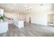 Open floor plan features a living area with a kitchen, island, recessed lighting, and modern flooring at 909 E Desert Ln, Phoenix, AZ 85042