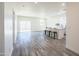 Light-filled living area featuring open layout and modern flooring that flows to kitchen and dining at 909 E Desert Ln, Phoenix, AZ 85042