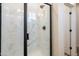 Updated walk-in shower with a glass door and sleek, black hardware at 909 E Desert Ln, Phoenix, AZ 85042