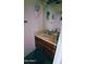 Bathroom featuring a single sink vanity with decorative wall art and a patterned bath mat at 921 W University Dr # 1101, Mesa, AZ 85201