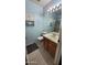 Bathroom with blue walls featuring a single sink vanity and a walk-in shower at 921 W University Dr # 1101, Mesa, AZ 85201