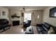 Inviting living room with a fireplace, ceiling fan, and comfortable leather seating at 921 W University Dr # 1101, Mesa, AZ 85201