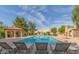 Community pool with lounge chairs and shade structures at 921 W University Dr # 1101, Mesa, AZ 85201