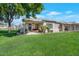 Lush green backyard featuring a covered patio perfect for outdoor entertaining and leisure at 9705 E Carefree Way, Chandler, AZ 85248