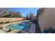 Backyard oasis featuring a rock-bordered pool, covered patio, and lush landscaping at 1001 N Nielson St, Gilbert, AZ 85234