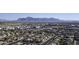 An aerial view showing the neighborhood with mountain views in the distance at 11408 E Natal Ave, Mesa, AZ 85209