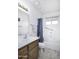 Clean bathroom with a single vanity, a shower-tub combination, and neutral tile flooring at 11408 E Natal Ave, Mesa, AZ 85209