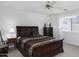 Serene bedroom with a classic dark wood sleigh bed and coordinated furnishings, inviting retreat at 11408 E Natal Ave, Mesa, AZ 85209