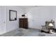 Serene bedroom with a soft color palette, a cozy chair, and a dresser with a mirror at 11408 E Natal Ave, Mesa, AZ 85209