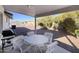 Inviting covered patio with outdoor furniture, offering a comfortable space for relaxation and dining at 11408 E Natal Ave, Mesa, AZ 85209