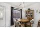 Cozy dining area with a chandelier, a china cabinet, and a window with natural light at 11408 E Natal Ave, Mesa, AZ 85209