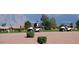Golf carts driving on a well-maintained course with a mountain backdrop, on a sunny day at 11408 E Natal Ave, Mesa, AZ 85209