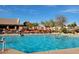 Community pool is a large in ground pool with plenty of lounge chairs for sun bathing at 11408 E Natal Ave, Mesa, AZ 85209