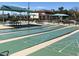 The shuffleboard courts feature shaded picnic tables and benches perfect for community activities at 11408 E Natal Ave, Mesa, AZ 85209