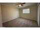 A cozy bedroom featuring gray brick walls, a ceiling fan, and carpet flooring at 15012 N 29Th Ave, Phoenix, AZ 85053