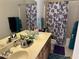Bathroom featuring double vanity, ample counter space, and a shower-tub combo with stylish curtains at 15650 N 19Th Ave # 1189, Phoenix, AZ 85023
