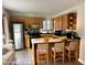 Functional kitchen features a stainless steel refrigerator, tile floors, breakfast bar, and ample cabinet space at 15650 N 19Th Ave # 1189, Phoenix, AZ 85023
