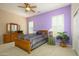 Bedroom with a ceiling fan, shutters, a dresser, and neutral wall colors at 16935 W Desert Blossom Way, Surprise, AZ 85387