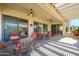 Relaxing covered patio with comfortable seating and ceiling fans, ideal for outdoor living at 16935 W Desert Blossom Way, Surprise, AZ 85387